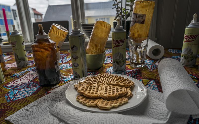 Waffles on a plate, jam, and cream in a home in Þingholt.