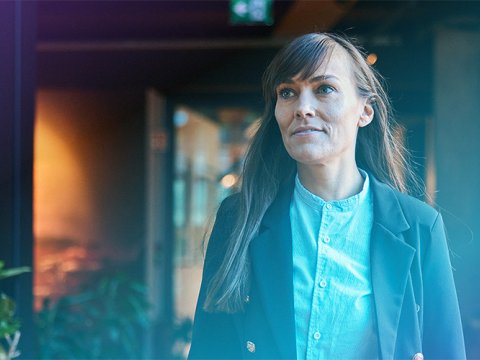 Woman in a hallway at a company.