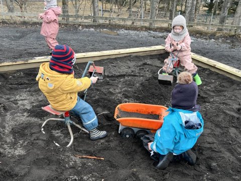 Children playing in a sandbox.