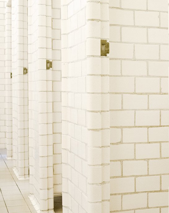 Original individual stalls in the men's changing room at Sundhöll Reykjavík Pool