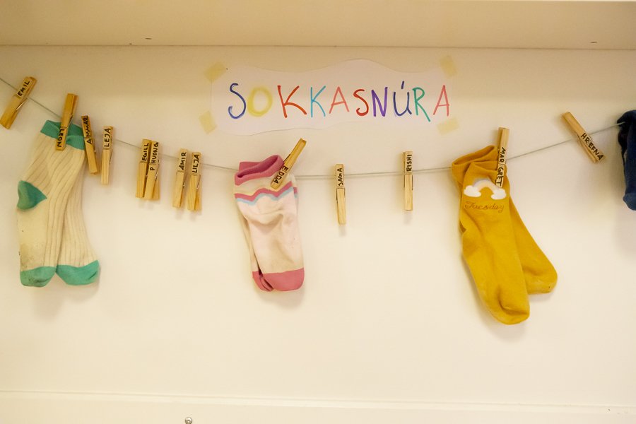 Socks on a clothesline with a sign above that reads "Sokkasnúra."