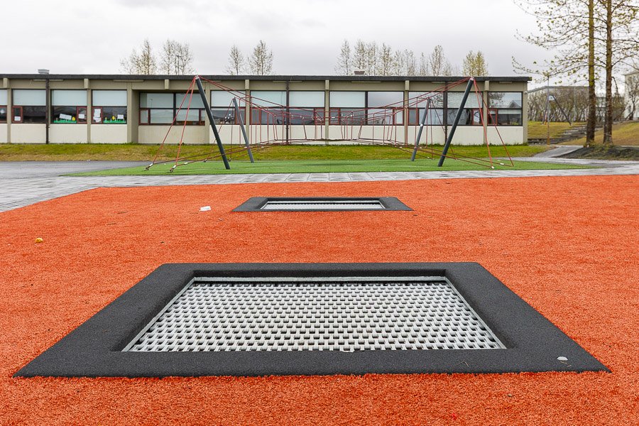 Trampoline on red surface. 