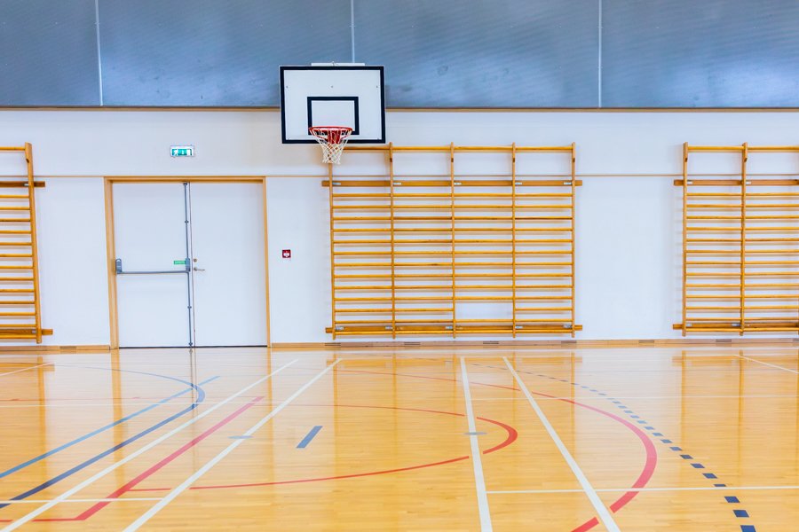 A gymnasium with a basketball hoop.