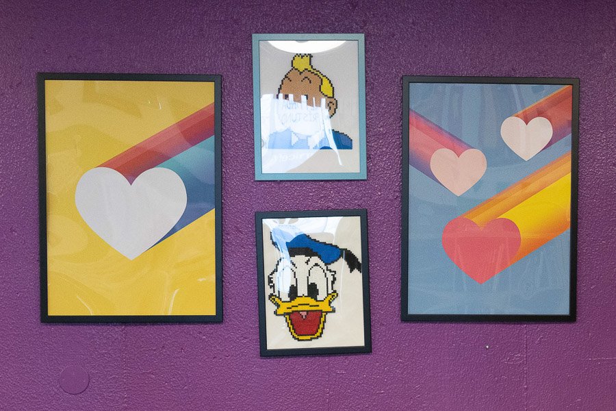 Purple wall at the Frostheimar after-school program with pictures of hearts, Donald Duck and more.