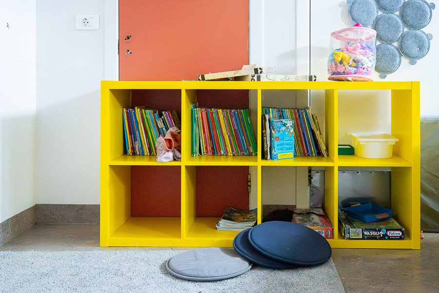 Yellow bookshelf and blocks in the foreground at the Glaðheimar after-school program