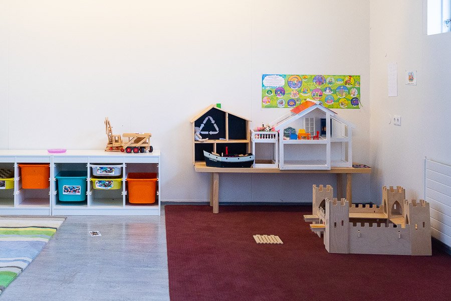 A play area with a small castle, dollhouse and other toys at the Halastjarnan after-school program.