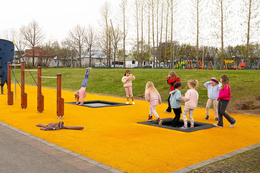 Children playing on bouncy mats at Laugarsel after-school program. 