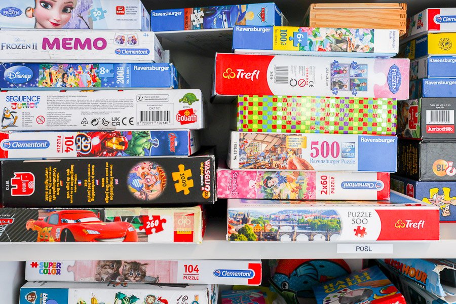 Puzzles on a shelf.
