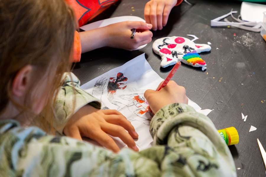 Children sit at a table drawing.