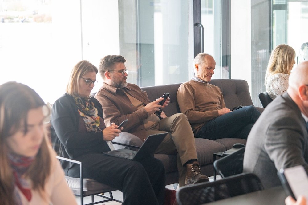 Attendees seated on a sofa