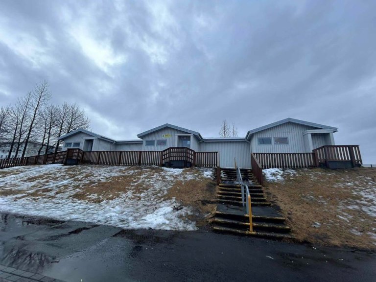 Bakkasel Recreation Center buildings on a hill. Steps leading up to the building with grass to the side. 