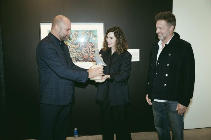 Rúnar Freyr Gíslason, chair of the Cultural Council, presents David Leitch and Kelly McCormick with the RIFF honorary award