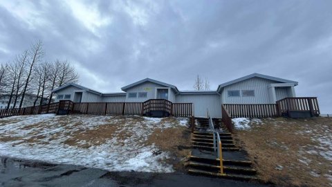 Bakkasel Recreation Center buildings on a hill. Steps leading up to the building with grass to the side. 